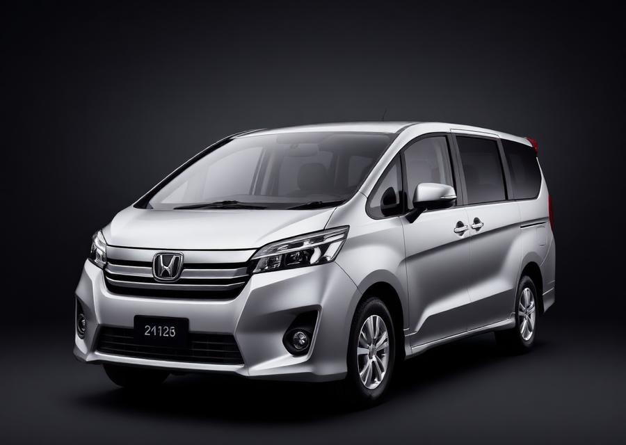 Silver seven-seat family MPV on a dark studio background